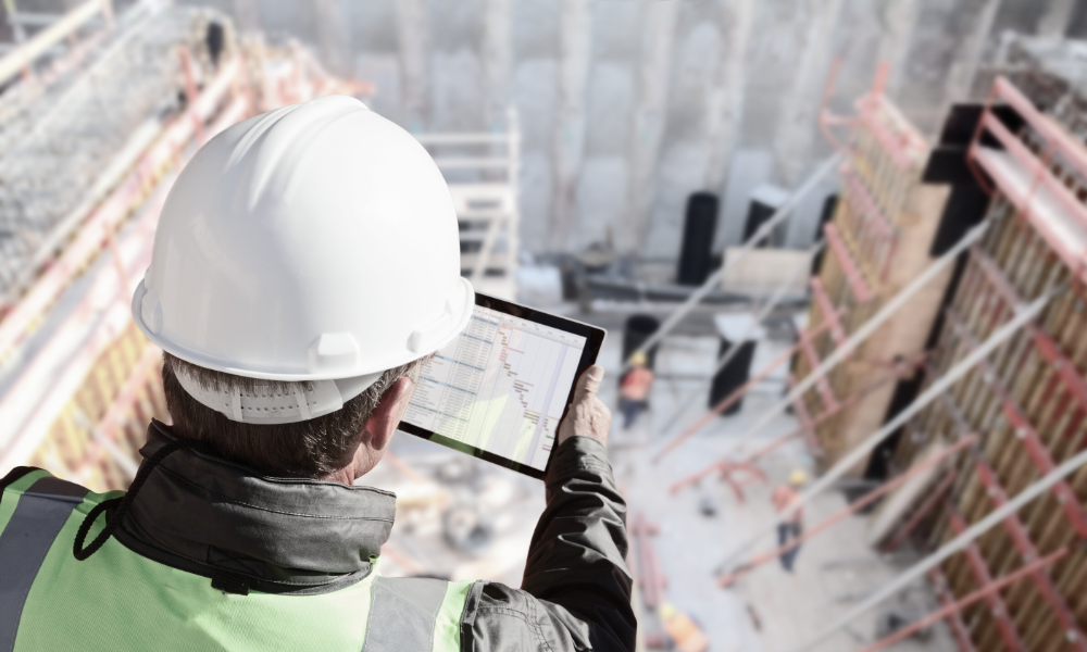 A mobile device displays project documents being accessed from a construction site, showcasing the seamless file sharing and management capabilities for architecture, engineering, and construction (AEC) teams. The image illustrates the importance of real-time access to sensitive project data and collaboration among external partners, ensuring compliance and efficient workflows.