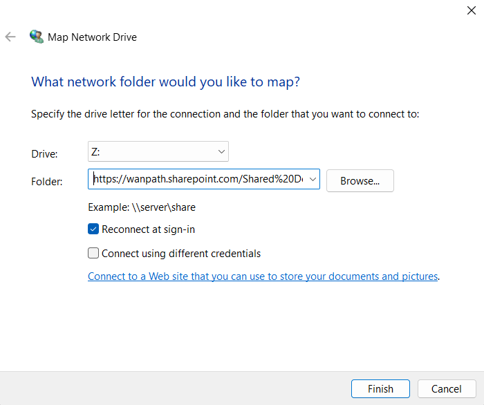 Screenshot: Windows 11 Map Network Drive dialog box with a drive letter selected (Z:), the Folder field filled in with a SharePoint Online library URL such as https://yourtenant.sharepoint.com/sites/Finance/Shared Documents, and the Reconnect at sign-in checkbox ticked.